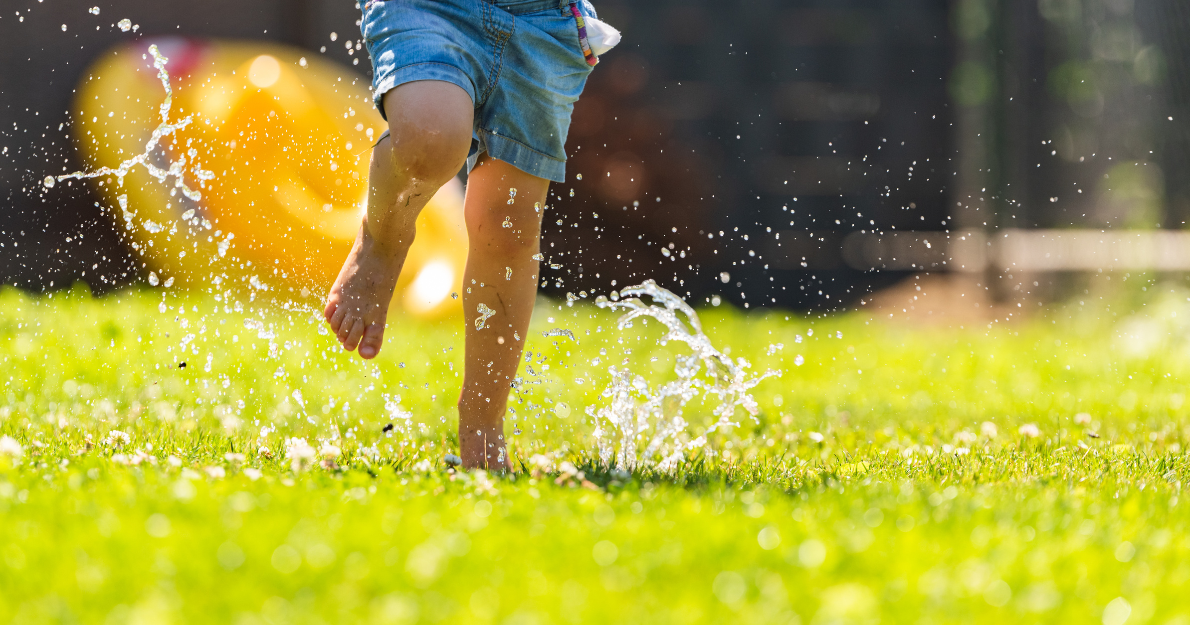 Child Running through Wet Lawn 